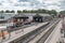 Children`s well-know train character seen on a full size steam locomotive, seen from the footbridge of a railway station.