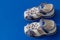 Children`s white orthopedic sandals on a blue background. Copy space, orthopedic comfortable shoes. Summer, leather