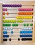 Children`s wooden abacus with knuckles yellow green lilac pink black. Toys, counting material