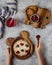 Children`s wooden plates in the form of animals, bear and elephant. The child eats porridge with berries, cookies and juice.