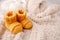 Children`s yellow knitted booties on a light gentle background. The concept of expecting a child, motherhood