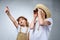 children in safari costumes and hats pointing and looking