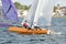Children Sailing a catamaran sailboat at speed with one hull air