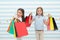 Children satisfied shopping striped background. Obsessed with shopping and clothing malls. Discount concept. Kids cute