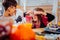 Children scaring each other while having cookies in the form of eyes for Halloween