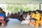 Children in school assembly under cover of roof