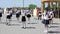 Children in sea form dance on embankment in city slow-motion shooting