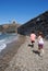 Children searching stones in a beach of Collioure, Colliure, small french village with a fortress in a sunny day of summer.