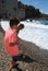 Children searching stones in a beach of Collioure, Colliure, small french village with a fortress in a sunny day of summer.