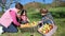 Children and senior woman putting apples inside of