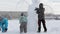 A children is shaping a snowman in heavy snow