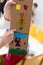 Children is showing drawing made on cardboard. Cardboard