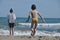 Children, siblings playing on the sea shore. They jumping in the waves