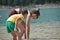 Children, siblings playing in the water. Black lake in the Durmitor mountains near Zabljak. A beautiful place in Montenegro