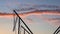 Children silhouettes are jumping on bungee trampoline against sky, slow mo