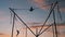 Children silhouettes are jumping on bungee trampoline against twilight sky