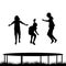 Children silhouettes jumping on garden trampoline