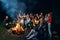 Children singing near camp fire.