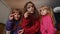 Children sisters girls holding magnifying glass near face, looking into camera, analysing, playing