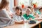 Children sit together at the table during the first physics lesson in the new school year