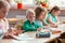 Children sit together at the table during the first physics lesson in the new school year