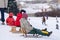 Children sit wooden sledge ready slide from hill