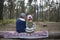 Children sitting on a log in the autumn forest and waiting when