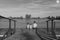 Children sitting on pier. Three children of different age - teenager boy, elementary age boy and preschool girl sitting