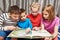 Children sitting and reading geography book