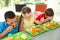 Children sitting at table and eating healthy food during break