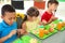 Children sitting at table and eating healthy food during break