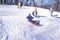 Children sled riding in Central Park, Manhattan, New York City, NY after winter snow storm