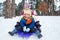 Children on sleds in snow