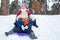 Children on sleds in snow