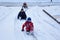 Children on a snowy road. Happy kids on winter break. Cheerful kids play outdoors in winter