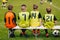 Children Soccer Team Sitting on a Bench. Kids Football Team Players