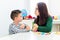 Children speech therapy concept. Preschooler practicing correct pronunciation with a female speech therapist.