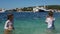 Children splashing water, life in a small Croatian resort town. Children and the sea, travel concept