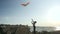 Children sports games. little kid boy control flying colorful kites. seascape sky clouds sun summer vacation