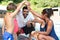 Children stacking hands with trainer at poolside