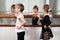 Children standing at ballet barre