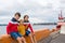 Children, standing at the edge of the port in Oslo, Norway, looking at water