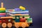 Children storybooks, wood toys, puzzle color train wagons stand on dark blue background