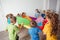 Children stretching colorful parachute for fun team games