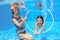 Children swim in pool underwater, happy active girls have fun under water, kids sport
