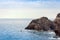 Children swim in the sea near rocks of the Cyclops, sea stacks in Acitrezza, Catania, Sicily, Italy