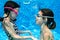 Children swim in swimming pool underwater, happy active girls have fun under water, kids fitness and sport