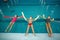 Children swimming group lies on back in the pool