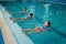 Children swimming group, workout with dumbbells