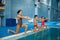 Children swimming group, workout at the poolside
